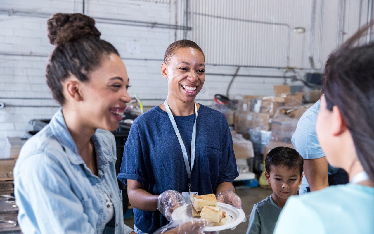 People volunteering at a food bank event.